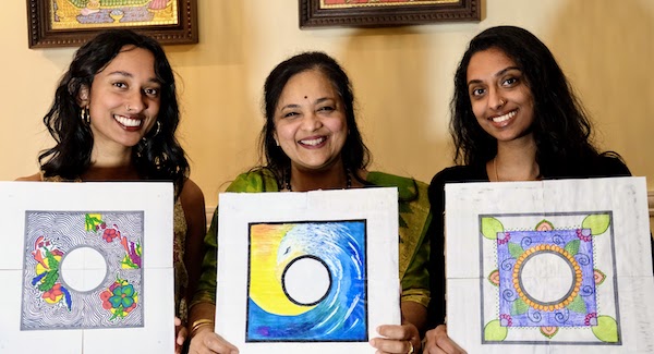 Three Indian women with kolams