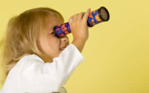 Little girl looking through a kaleidoscope at Richmond Restaurant Week Image