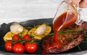 pouring ketchup on a steak. For the article on how to blame bad behavior on your state Image
