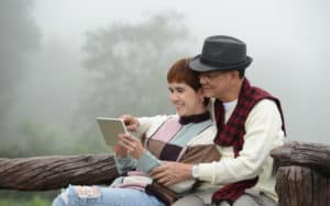 Baby boomer couple reading digital tablet Image