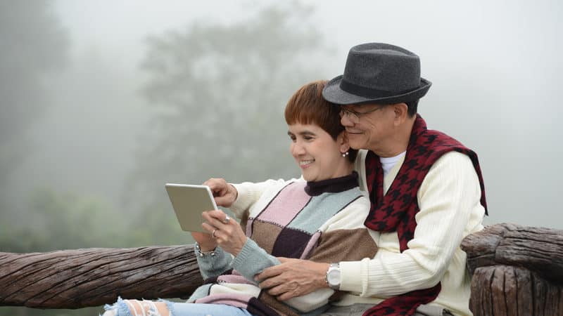 Baby boomer couple reading digital tablet Image