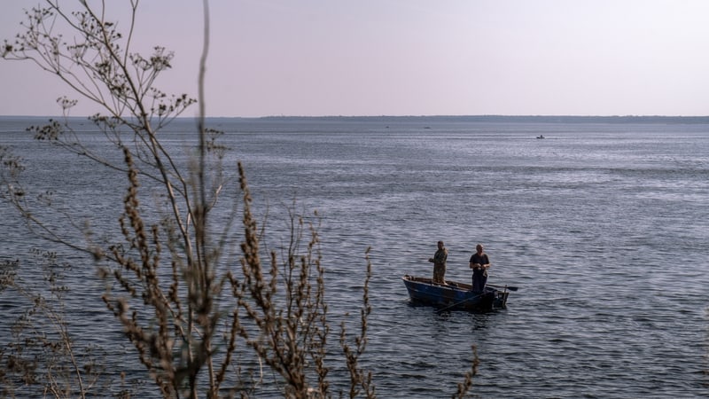 Two men fishing on a lake for article on Ditching worries and finding closure