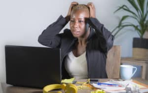 Overwhelmed woman at work Image