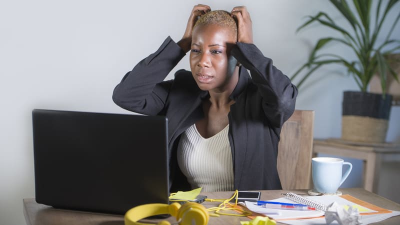 Overwhelmed woman at work