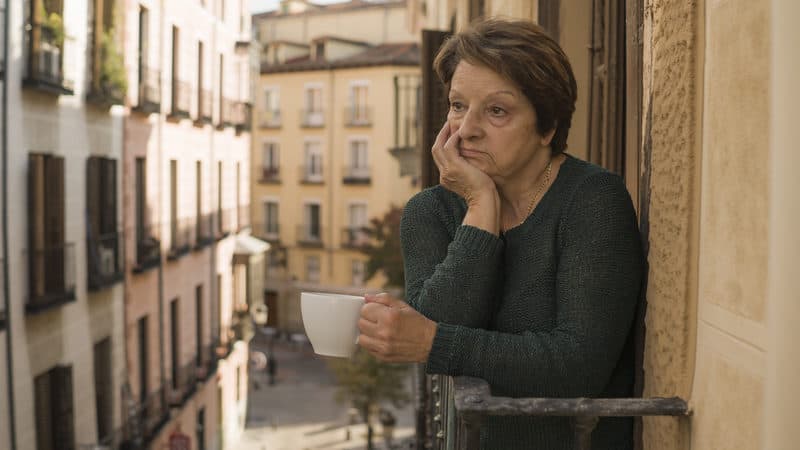 Senior woman on balcony gets no appreciation Image
