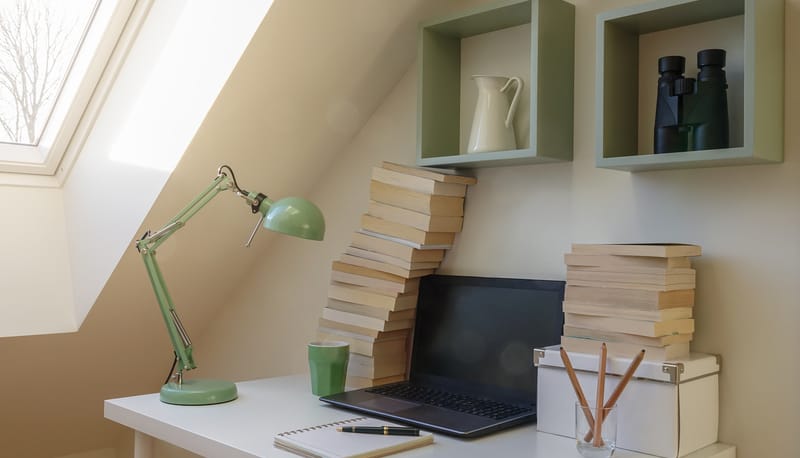 old books and a laptop in a small working nook. For Starting Again as a Writer later in life