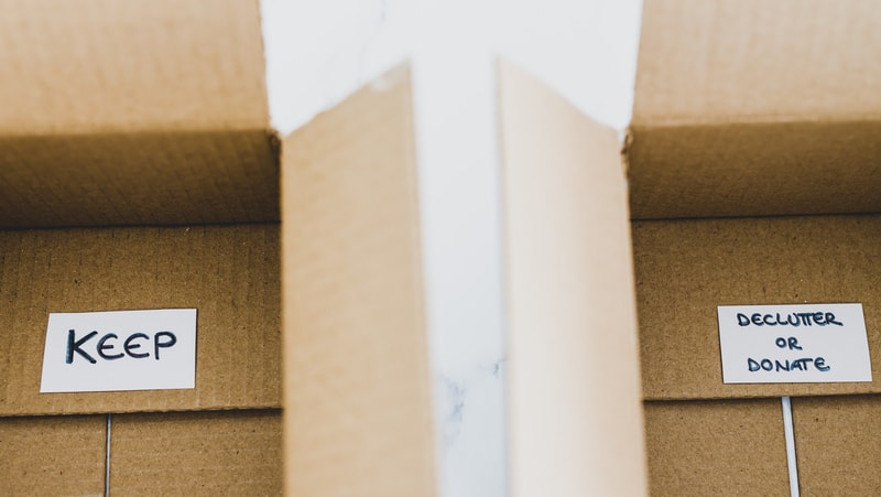 Two empty boxes, one labeled "Keep" and the other labeled "declutter or donate." For Planning and Decluttering for a Senior Move