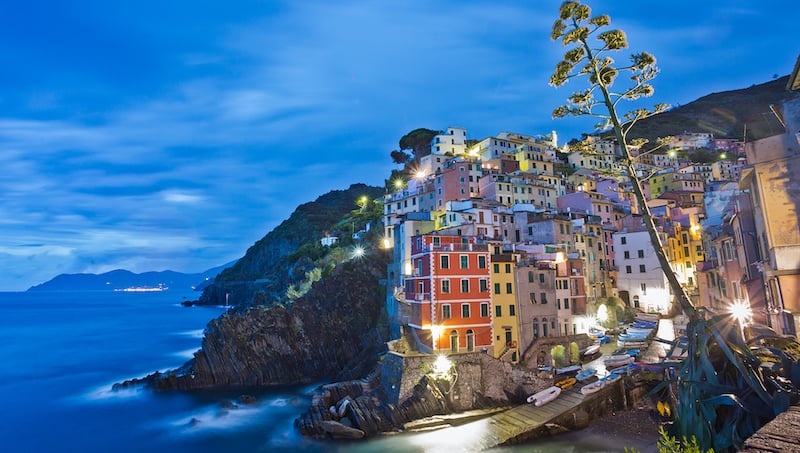 Riomaggiore, one of the Cinque Terre towns, is aglow at night. Credit, Rick Steves' Europefor Sciacchetrà wine and traditions
