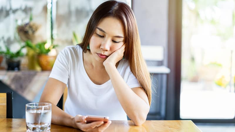 Young woman waiting for response from her biological father