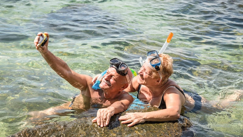 senior snorkelers. Credit: mirko vitali dreamstime. For article on Boomers Financing Post-COVID Travel