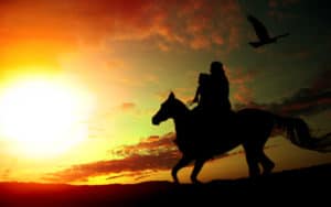 Father and daughter on a horse, silhouetted against the setting sun. For Farmer and father fights COVID Image