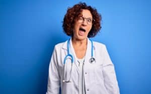 Sexy female doctor winking. For article on funny reasons not to date health professionals Image
