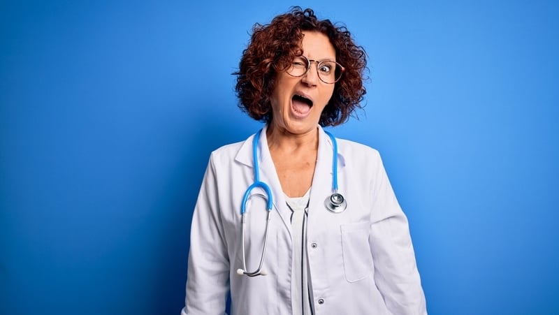 Sexy female doctor winking. For article on funny reasons not to date health professionals