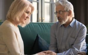 Senior man telling wife about surprise offspring Image