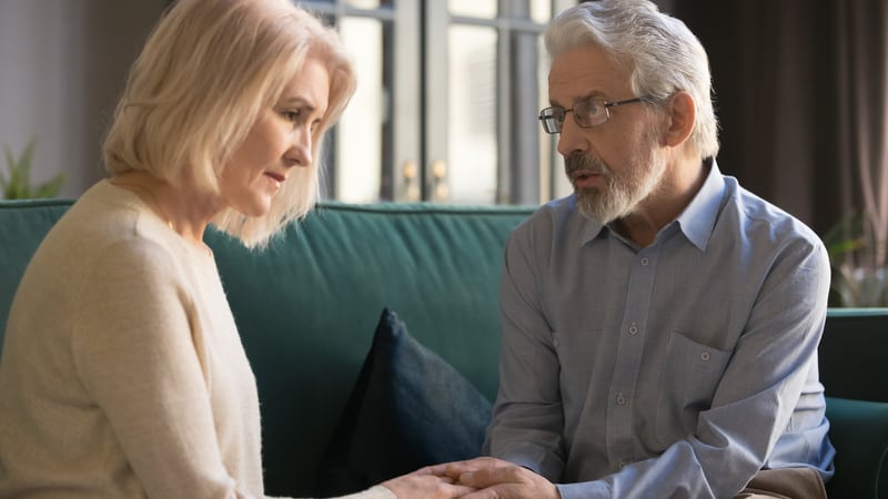 Senior man telling wife about surprise offspring