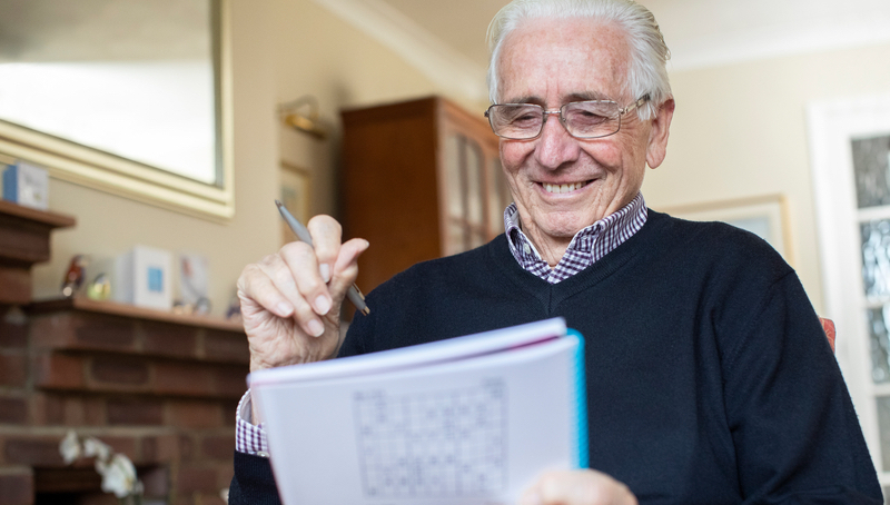 senior man doing puzzle. Image credit Katie Nesling Dreamstime.com