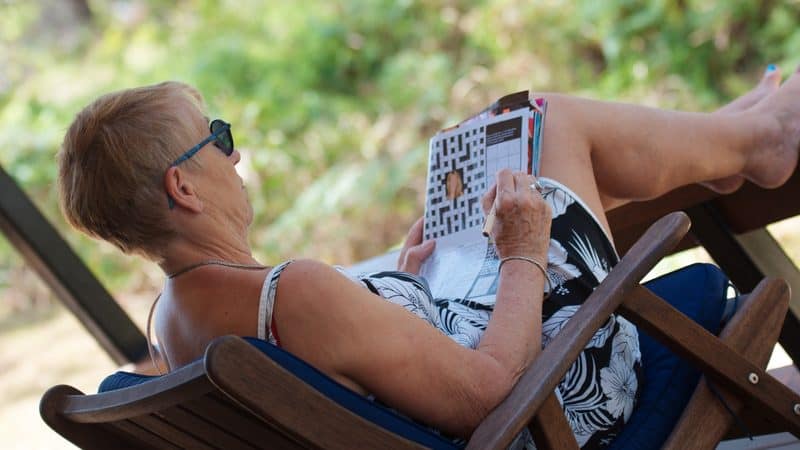 senior woman doing puzzle Rozenn Leard Dreamstime.com Image