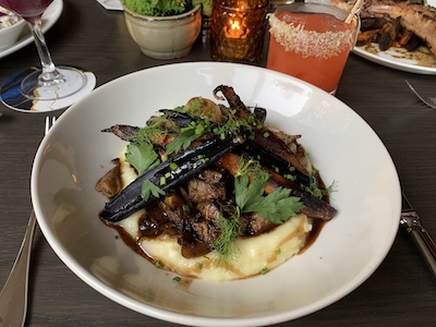 Braised Wagyu beef over mashed potatoes, grilled carrot, wild mushroom, thick-cut bacon, at Fall Line restaurant in Richmond