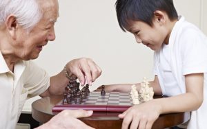 granddad and grandson playing chess game. Credit: Imtmphoto dreamstime Image