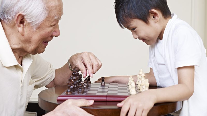 granddad and grandson playing chess game. Credit: Imtmphoto dreamstime Image