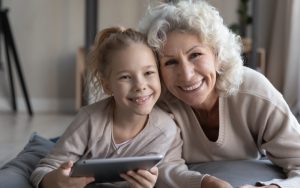 grandma grandaughter on tablet doing puzzle fizkes dreamstime Image
