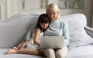 grandmom granddaughter on computer puzzle Credit: fizkes dreamstime Image
