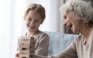 grandmother granddaughter playing tower puzzle Fizkes Dreamstime Image