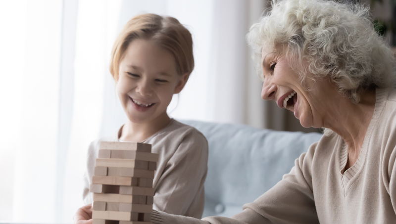 grandmother granddaughter playing tower puzzle Fizkes Dreamstime