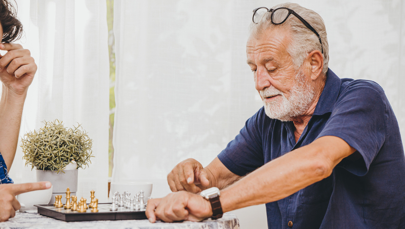 Man playing chess Photo Korn Vitthayanukarun Dreamstime2. For use with puzzles, boggle, games, etc.