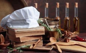 collection of old cookbooks, herbs, spices, and chef's hat. Photo by Igorr Dreamstime. For article on holiday books for cooks Image