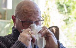 man with tissue to his nose Photo Dasya11 Dreamstime. For article on unexpected allergy Image