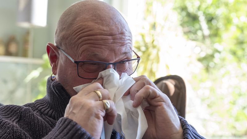 man with tissue to his nose Photo Dasya11 Dreamstime. For article on unexpected allergy Image
