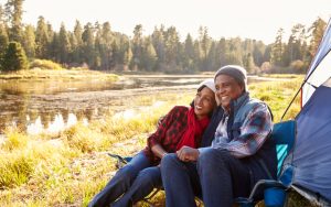 a tent and a couple on an autumn camping trip, seniors camping Photo Monkey Business Images Dreamstime For article, Gear Essentials for Your Backpacking Adventure Image