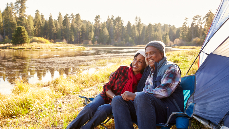 a tent and a couple on an autumn camping trip, seniors camping Photo Monkey Business Images Dreamstime For article, Gear Essentials for Your Backpacking Adventure