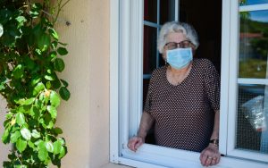 woman wearing mask at home Photo by Jpwallet Dreamstime. For article on pandemic paranoia Image