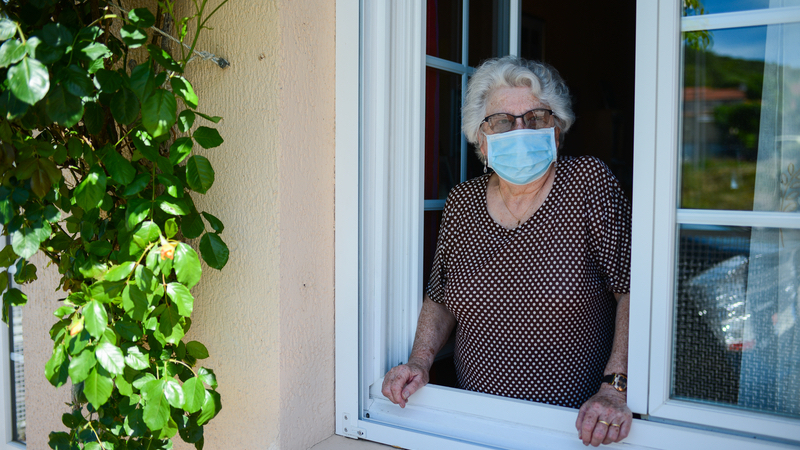 woman wearing mask at home Photo by Jpwallet Dreamstime. For article on pandemic paranoia