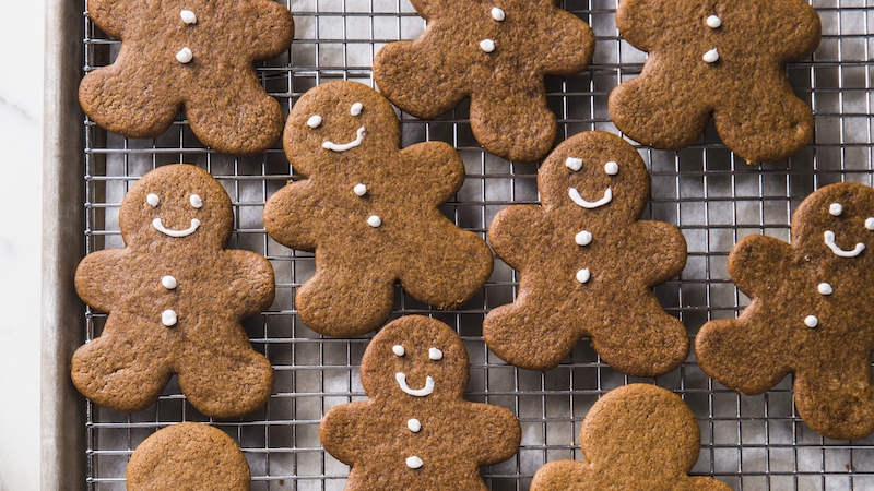 freshly baked gingerbread cookies on a cooling rack. For article on Chewy and Soft Gingerbread People Cookies