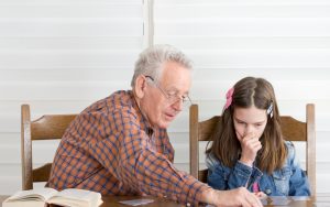 Grandad granddaughter doing a puzzle together Photo by Jevtic Dreamstime Image