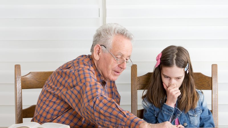 Grandad granddaughter doing a puzzle together Photo by Jevtic Dreamstime Image