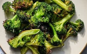 For article on air fryer broccoli: Air-fry slender stalks of broccoli for a tender and crispy-tipped side dish to serve all year long. Image