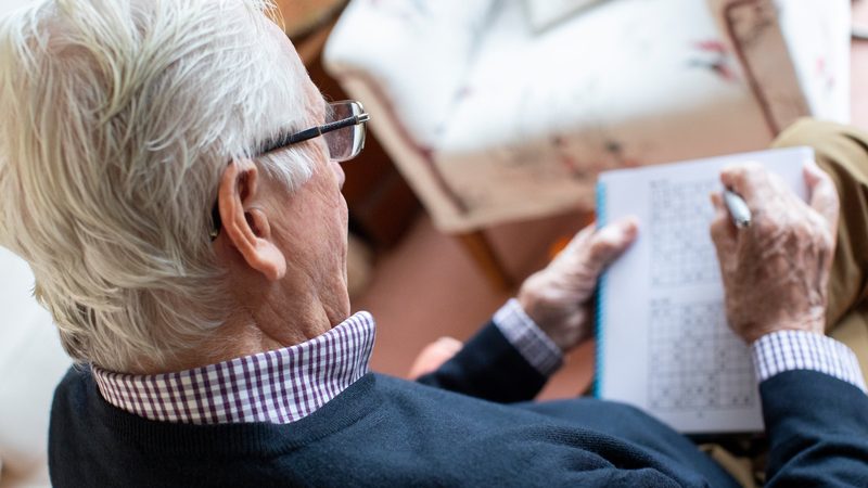 senior man doing puzzle Katie Nesling Dreamstime 2 Image
