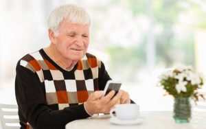 senior man using phone Photo by Hongqi Zhang (aka Michael Zhang) Dreamstime. For article on husband's Twitter alter ego Image
