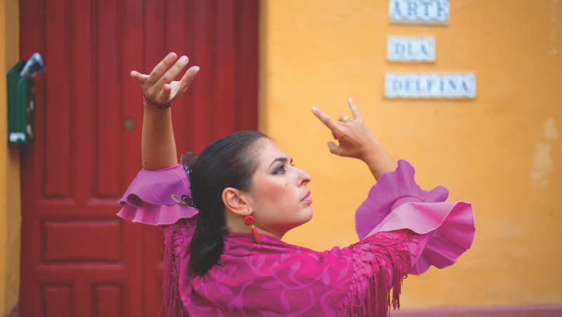 Andalucía celebrates life with soul and with passion. Here, a woman dances the flamenco.