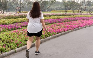 woman in park photo by Bignai Dreamstime. For article, Advice from Amy: ‘My Daughter Is Overweight’ Image