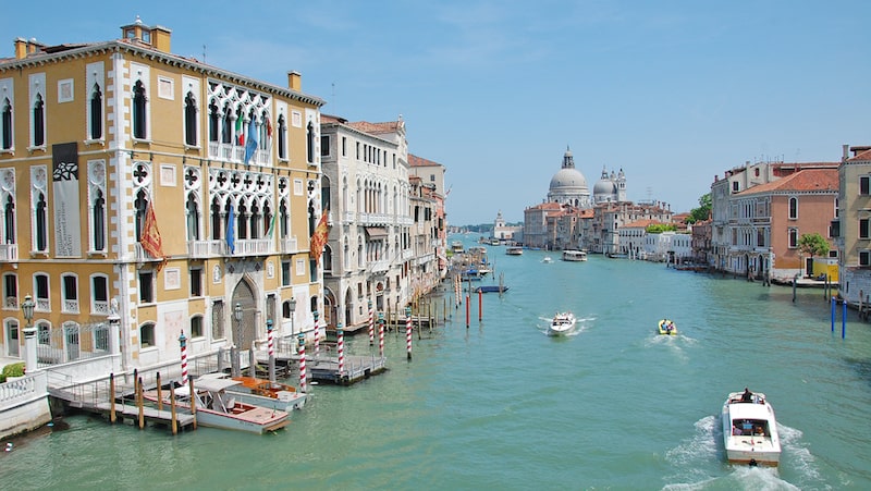 Rick Steves’ Europe: Piero’s in Venice. A picture of one of the Venetian canals, lined with buildings and traveled by boats Image