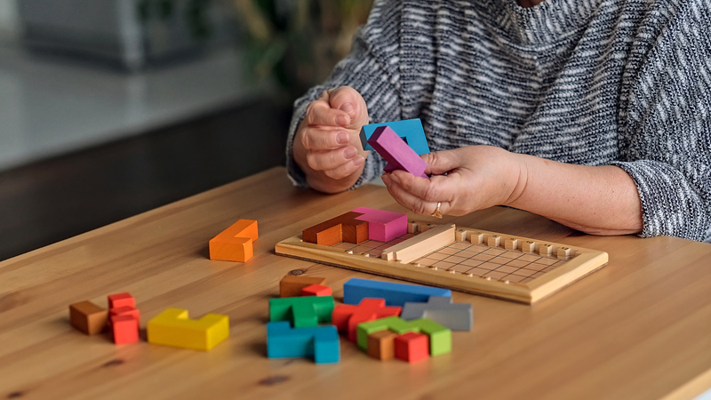 Woman doing three-dimensional Brain Training puzzle Photo Elvira Koneva Dreamstime