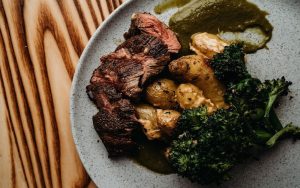 Charred pan seared sirloin with roasted fingerlings in paprika aioli, charred broccolini, and chimichurri at Charred Wood Fired Oven & Craft Bar. Photo from Charred Swift Creek Facebook Image