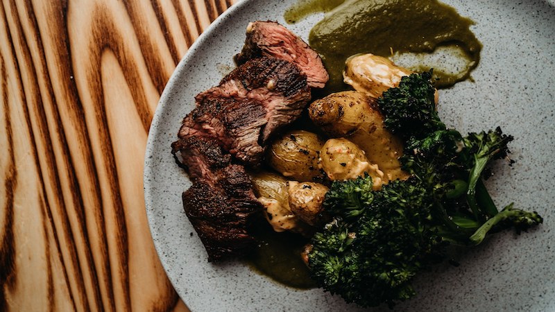 Charred pan seared sirloin with roasted fingerlings in paprika aioli, charred broccolini, and chimichurri at Charred Wood Fired Oven & Craft Bar. Photo from Charred Swift Creek Facebook