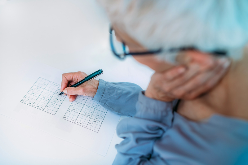 Man doing puzzle, possibly Sudoku