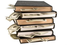 books with $100 bills sticking out Stokato Dreamstime. For article, The Best Financial Books of 2021 Image